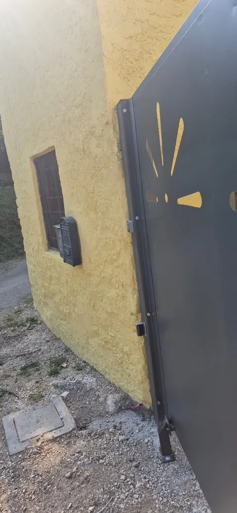 Canatul porții lângă zidul casei